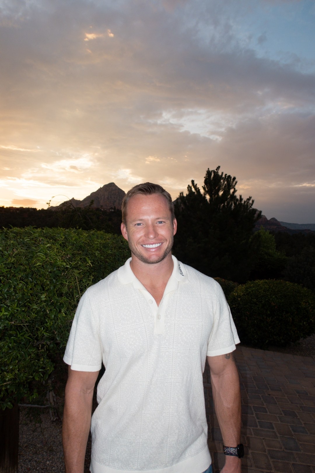 Jack Johnson at dusk in Sedona, with the red rock silhouette of Thunder Mountain in the background